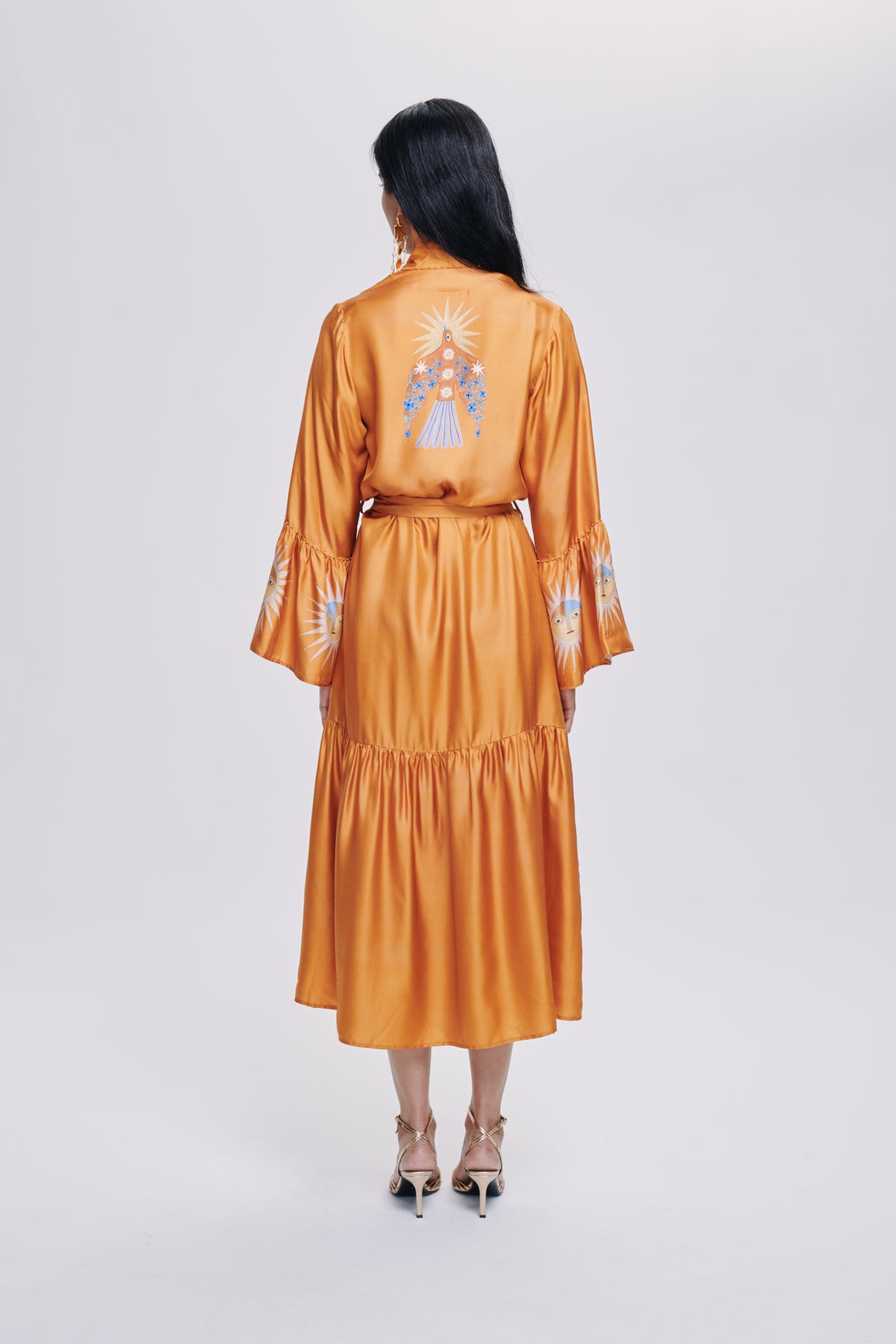 Carolina K Nico robe in soft fabric, stylish clothing with a relaxed fit, shown hanging on a wooden hanger.