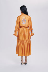 Carolina K Nico robe in soft fabric, stylish clothing with a relaxed fit, shown hanging on a wooden hanger.