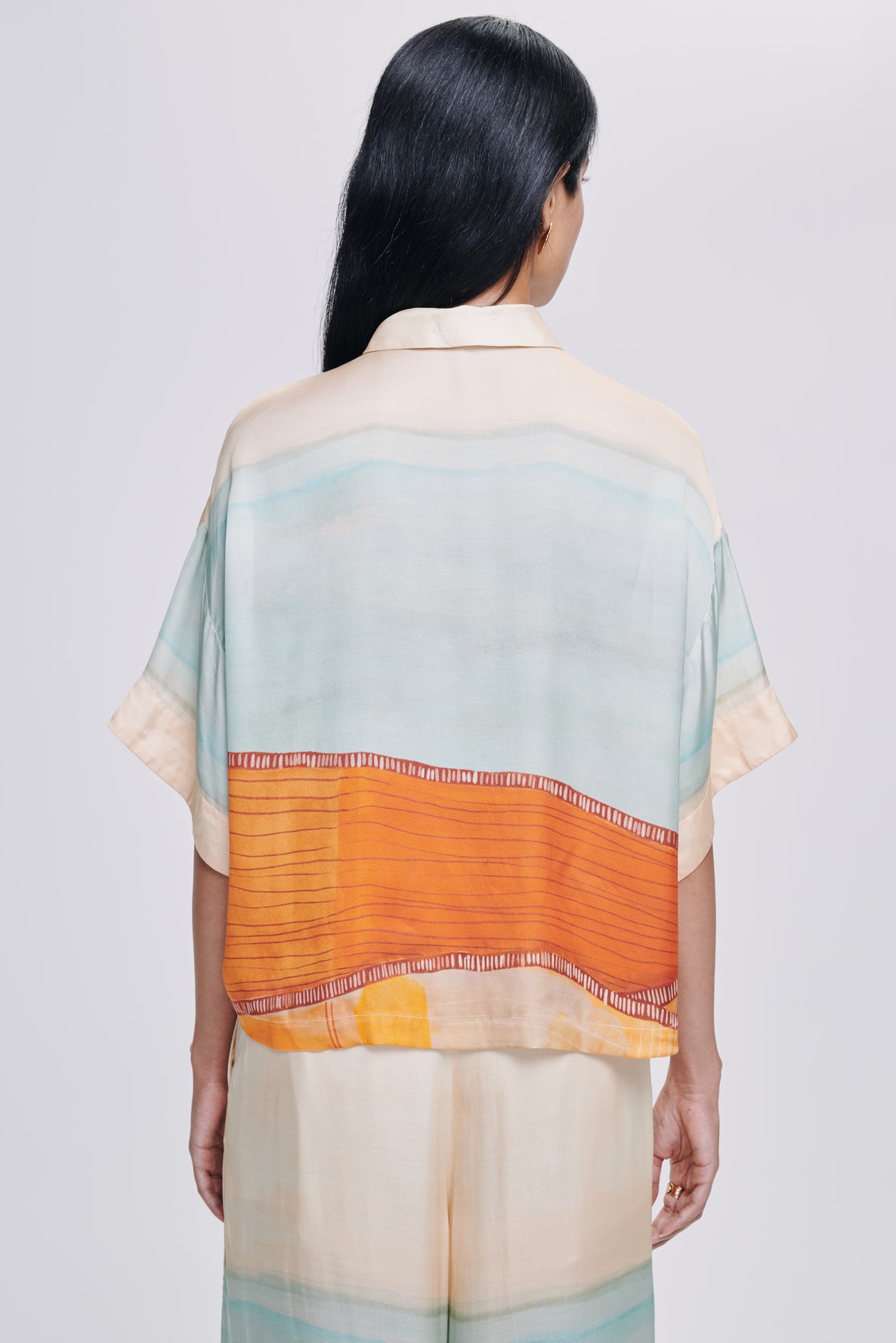 Carolina K kimono top, flowy lightweight clothing with vibrant patterns, styled on a model with long sleeves and relaxed fit.