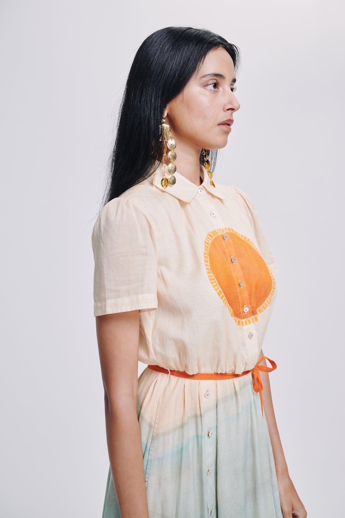 Carolina K Elisetta dress featuring a stylish, flowing design in vibrant fabric, shown on a model demonstrating the elegant clothing.