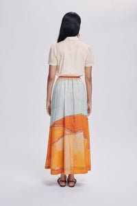 Carolina K Elisetta dress shown on a model, featuring vibrant patterns and flowing fabric, perfect for stylish, casual wear.