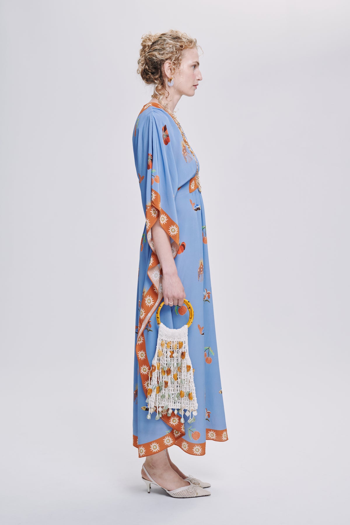 Carolina K Taiel kaftan in vibrant fabric, flowing design, worn as stylish clothing, showcasing intricate patterns and elegant drape.