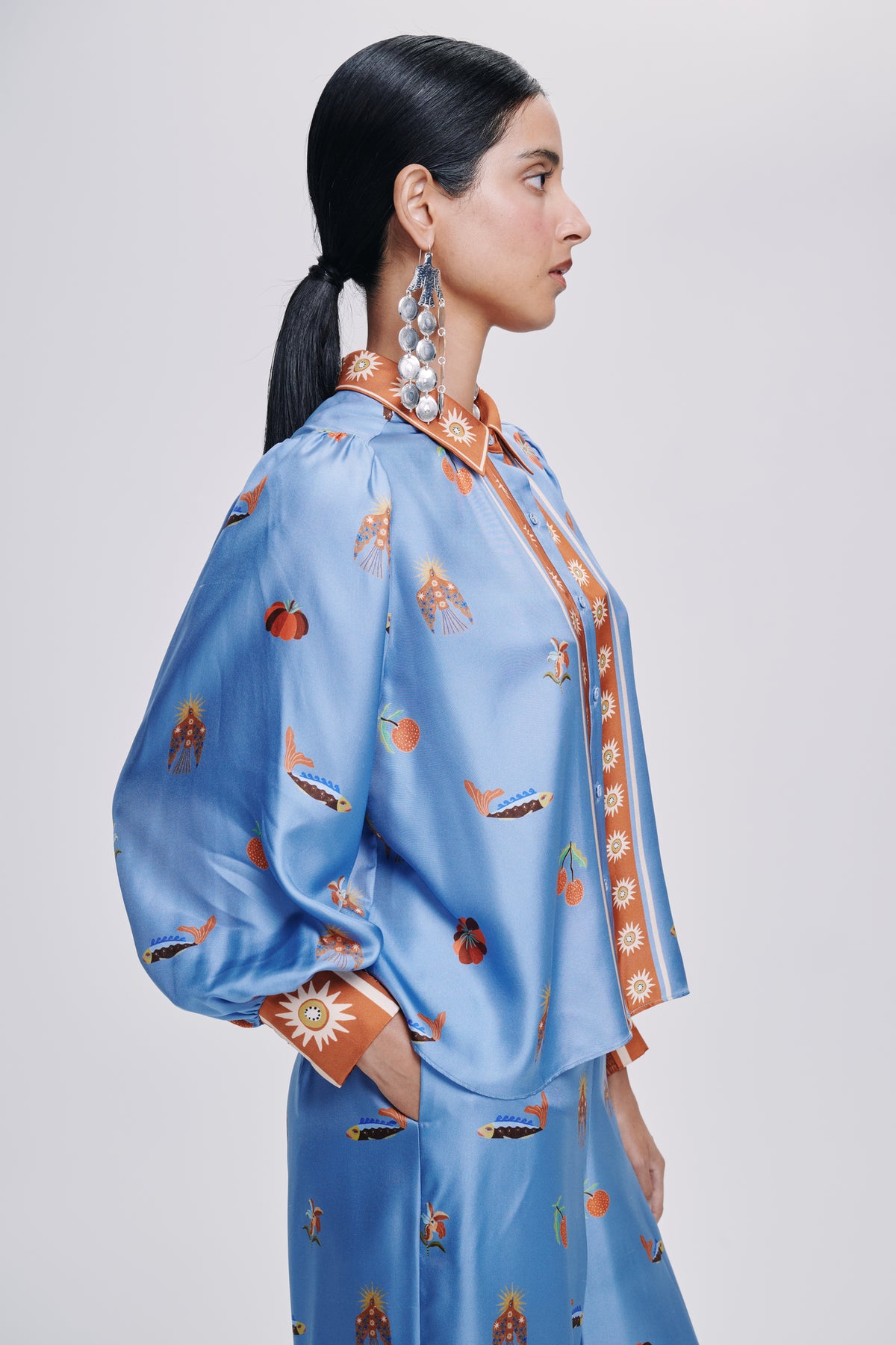 Carolina K palazzo pants in flowing fabric with wide legs and a vibrant print, shown on a model.