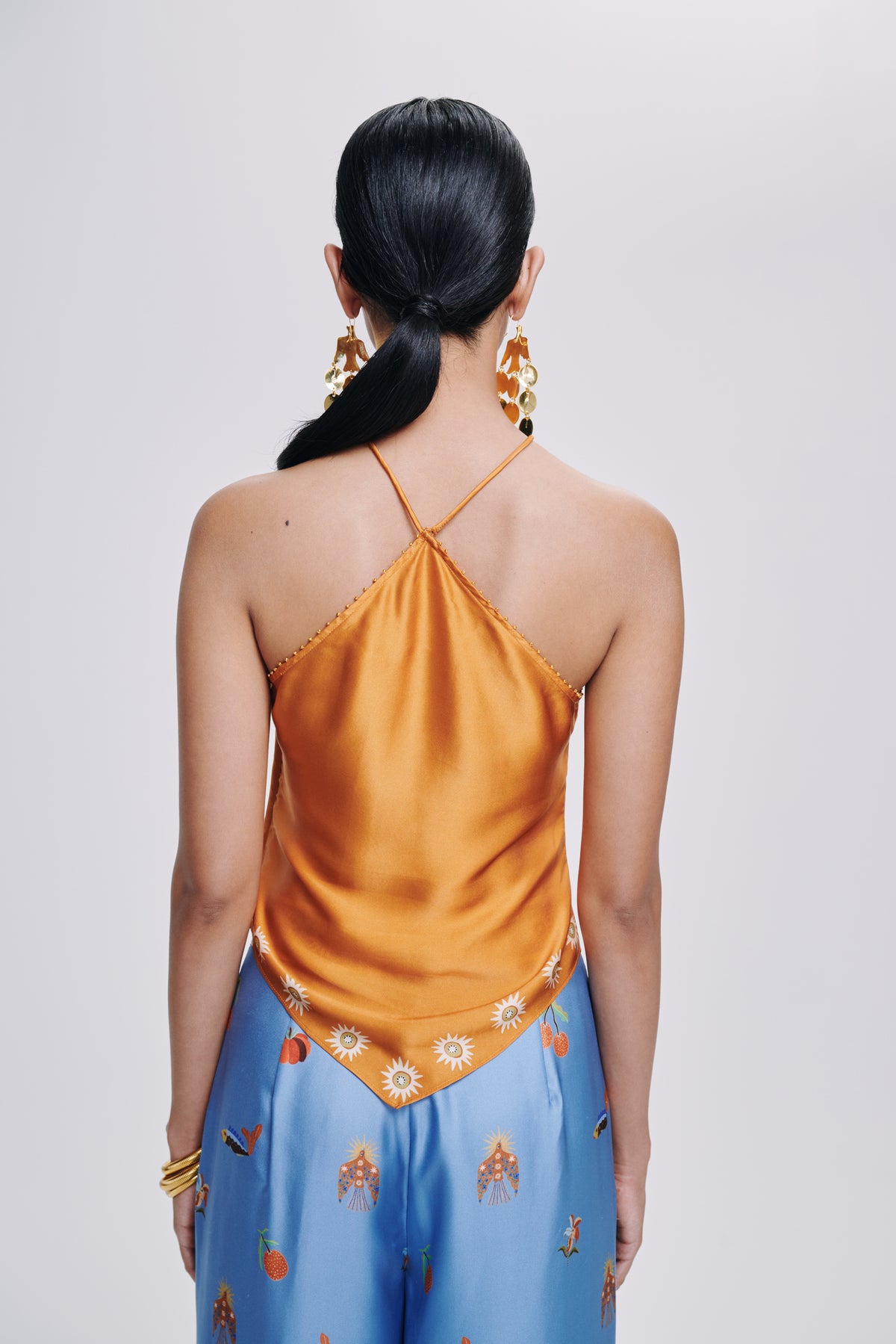 Carolina K Manu top, stylish clothing with a vibrant, patterned design, shown on a model in a fashion photoshoot.