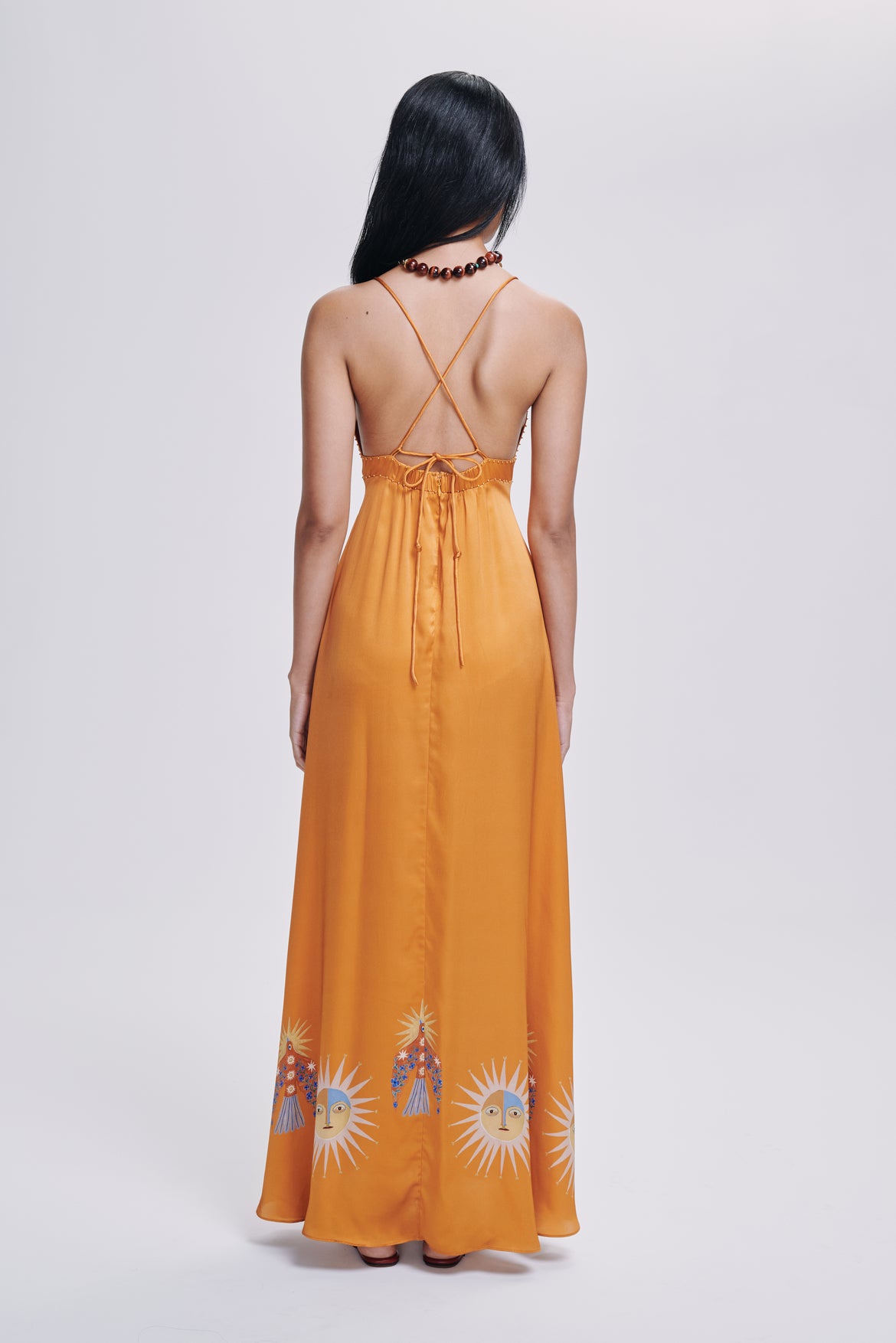Carolina K star dress, stylish clothing with star pattern, displayed on a hanger against a neutral background.