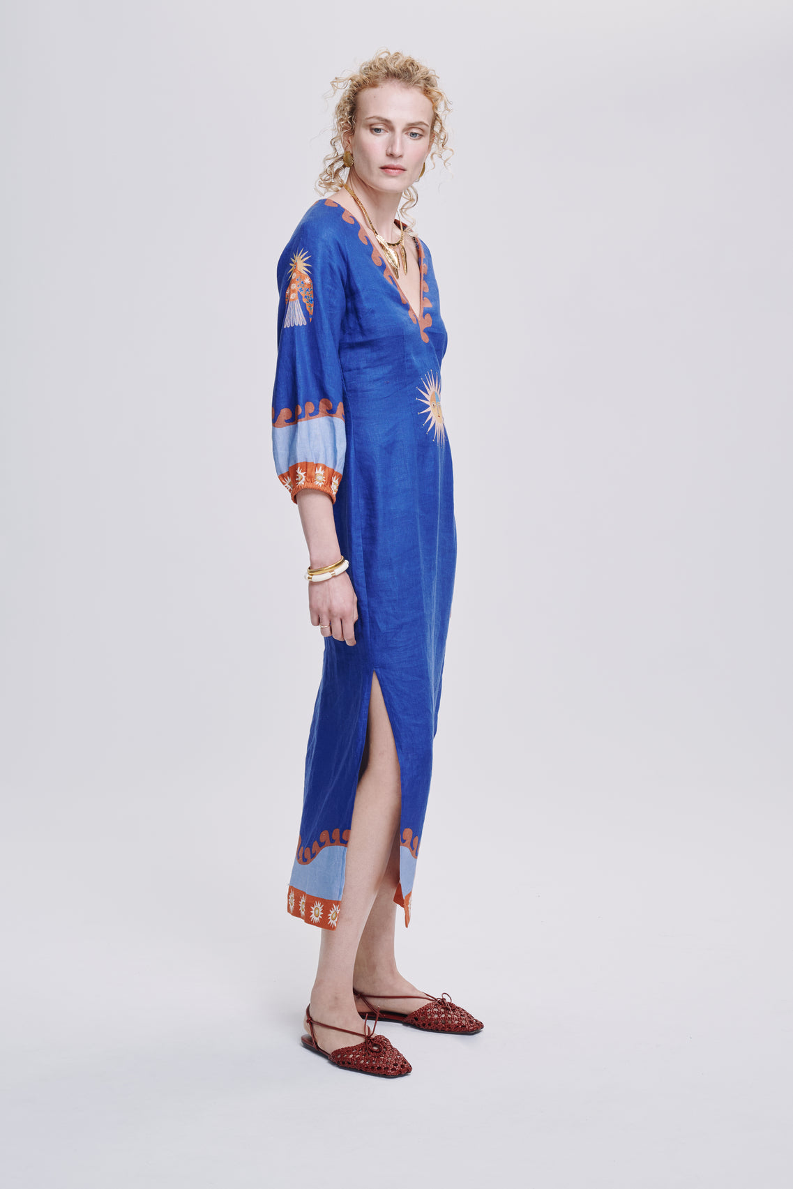 Carolina K Solan dress shown in vibrant, flowing clothing with intricate patterns and elegant design details.