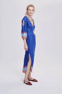 Carolina K Solan dress shown in vibrant, flowing clothing with intricate patterns and elegant design details.