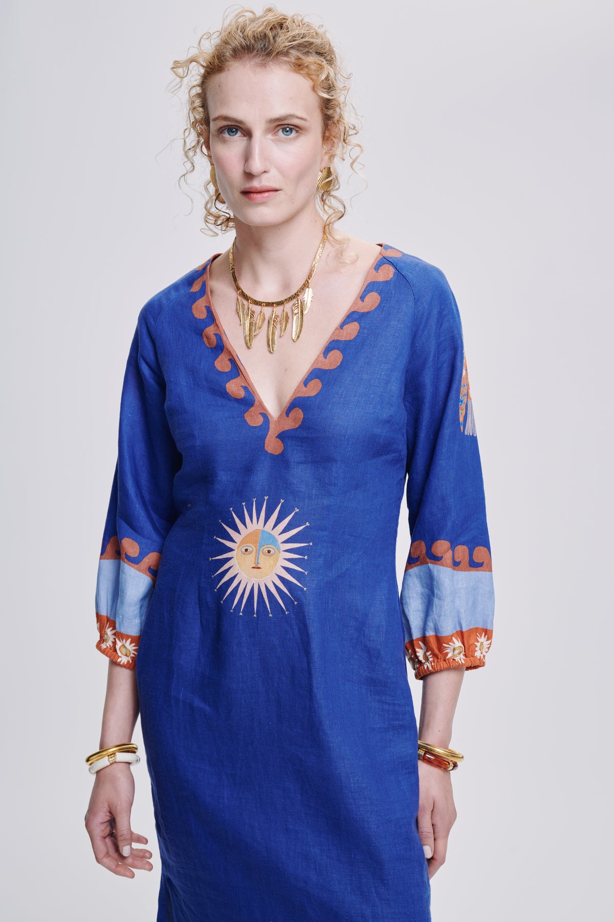 Carolina K Solan dress in vibrant patterned fabric, showcasing a stylish clothing design with flowing silhouette and bold colors.