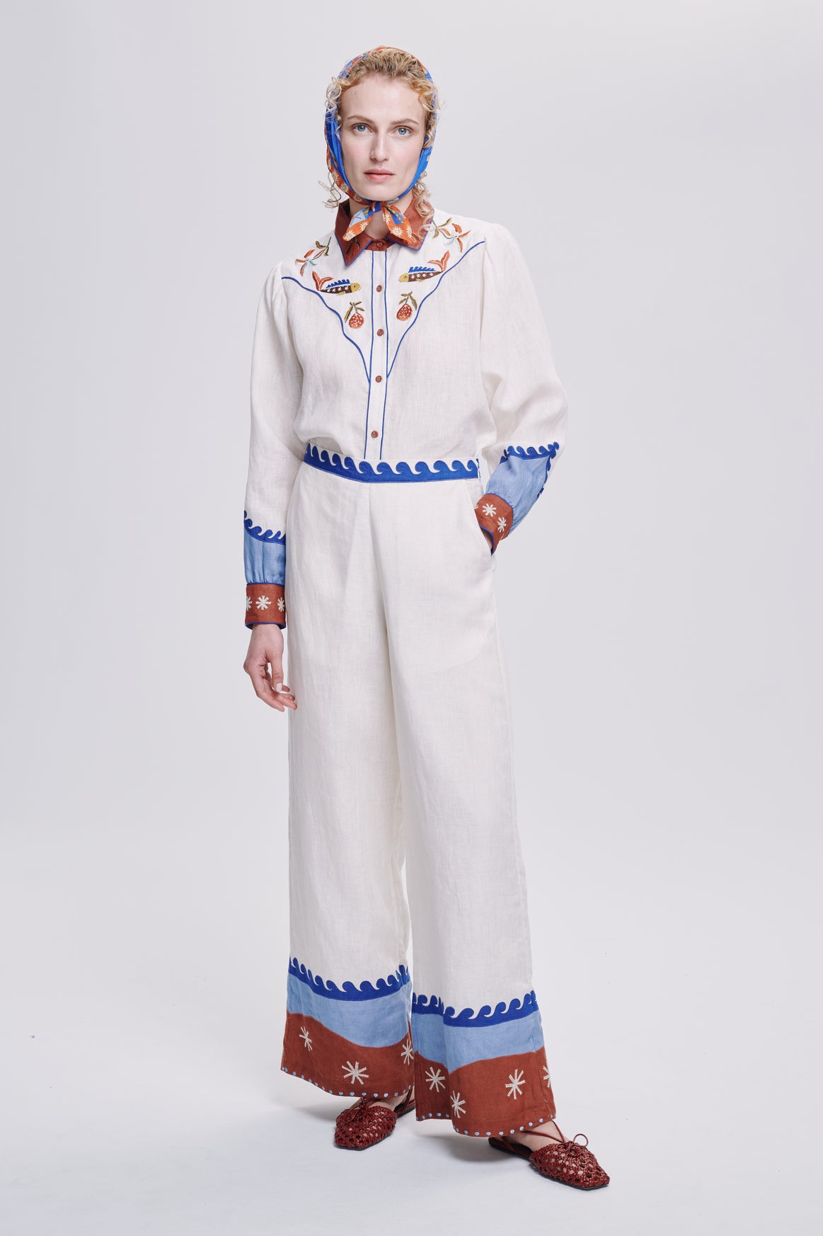 Carolina K palazzo pants in flowing fabric with wide legs and high waist, displayed in a stylish clothing photo.