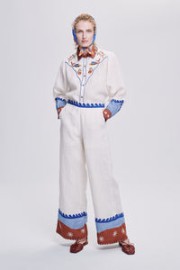 Carolina K Palazzo pants in flowing fabric with wide-leg design, shown on a model against a neutral background.