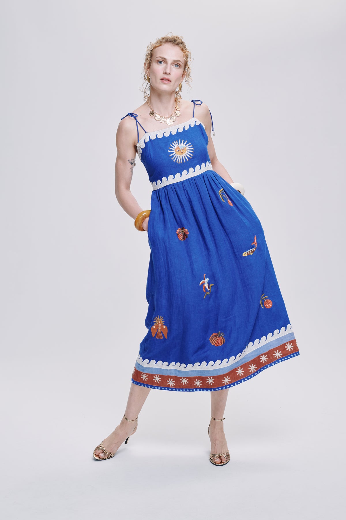Carolina K Allegra dress in vibrant patterned fabric, showcasing its flowing silhouette and stylish design.