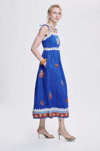 Carolina K Allegra dress in vibrant fabric with flowing silhouette, displayed on a model showcasing elegant women's clothing style.