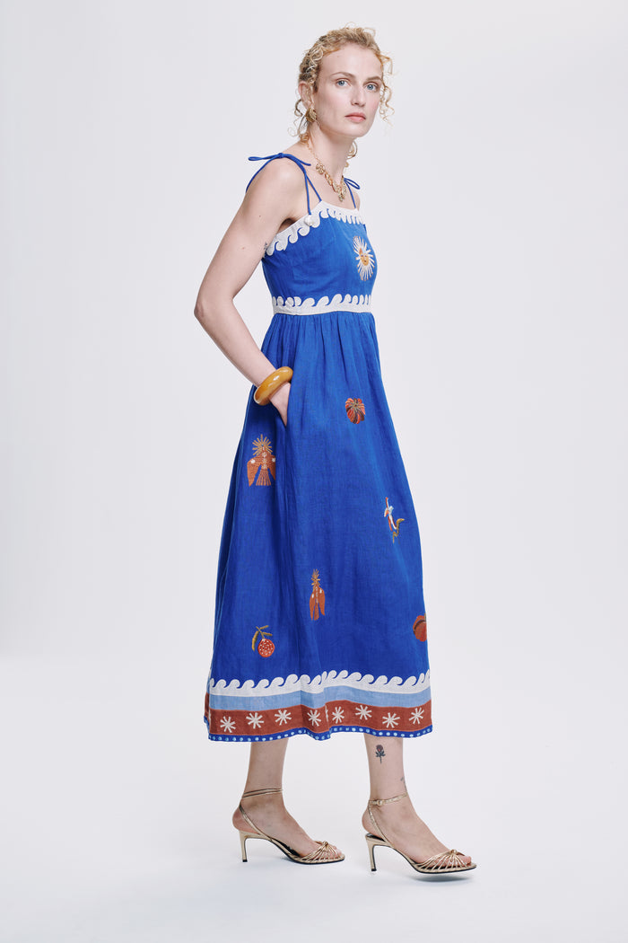 Carolina K Allegra dress in vibrant fabric with flowing silhouette, displayed on a model showcasing elegant women's clothing style.