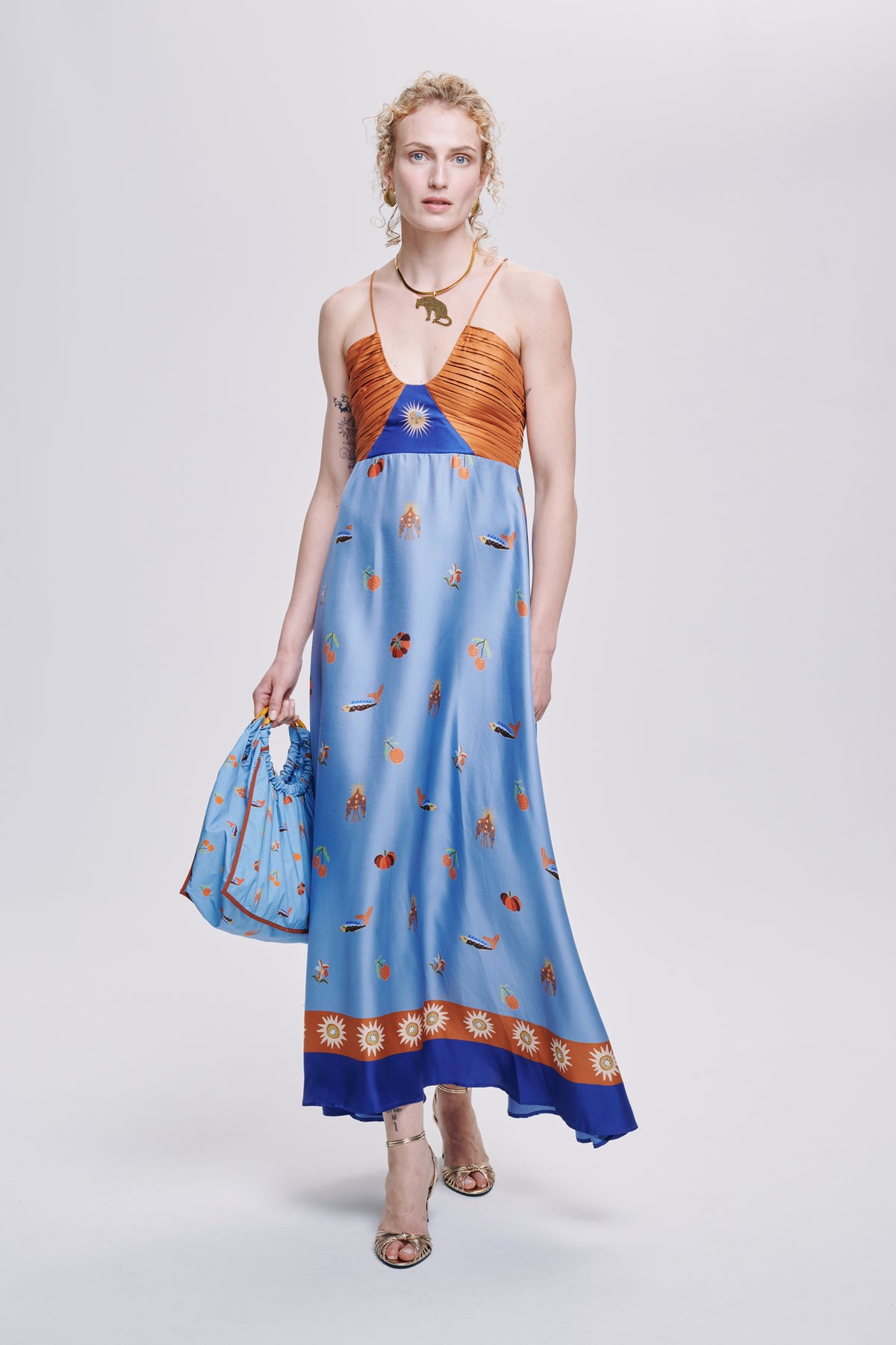 Carolina K Joyce dress displayed on a mannequin, featuring a stylish, flowing clothing design with intricate patterns and vibrant colors.