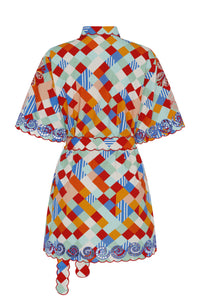 Short-sleeve mini shirt dress in a colorful geometric tile print. Features a self-tie waist belt, scalloped trim, and embroidered detailing along the sleeves and hem.