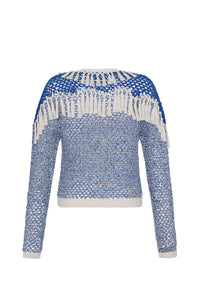 Hand-crocheted blue and ivory cardigan featuring an open-knit design, long sleeves, and statement fringe detailing across the shoulders and upper back. Finished with ribbed trim at the hem and cuffs.
