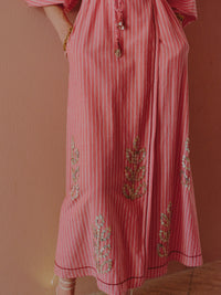 Detail of a pink striped midi dress featuring embroidered sequin motifs and a wrap silhouette.