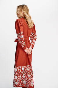 Carolina K Anais Dress in vibrant fabric, featuring flowing silhouette and intricate design details, displayed on a mannequin.