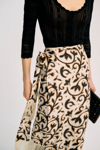 Carolina K Fauna Wrap Skirt in vibrant print, flowing fabric, styled with a waist tie and layered design.