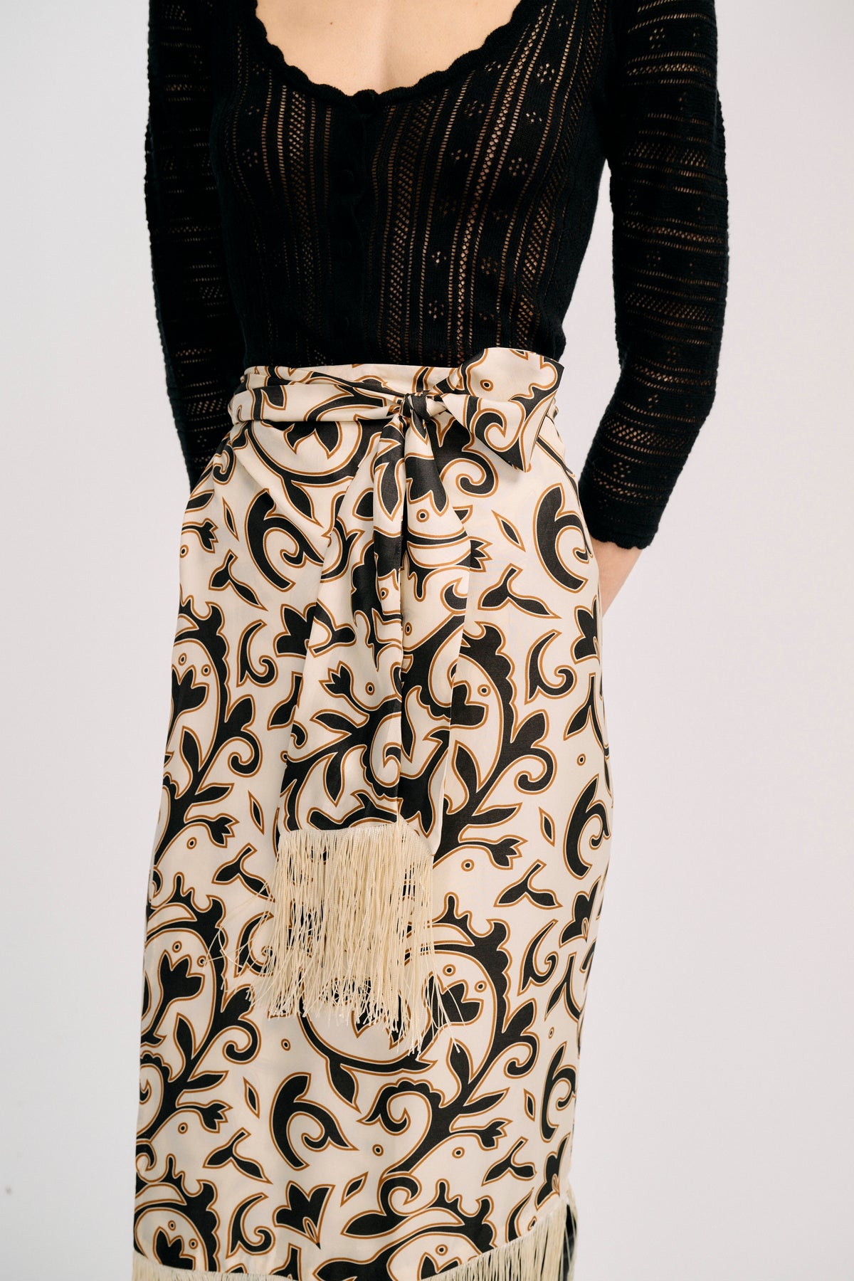 Carolina K Fauna Wrap Skirt in vibrant print, flowing fabric, shown on a model styled for casual or boho chic wear.