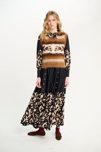 Carolina K Fox vest displayed on a hanger, showcasing its stylish design and fabric details.