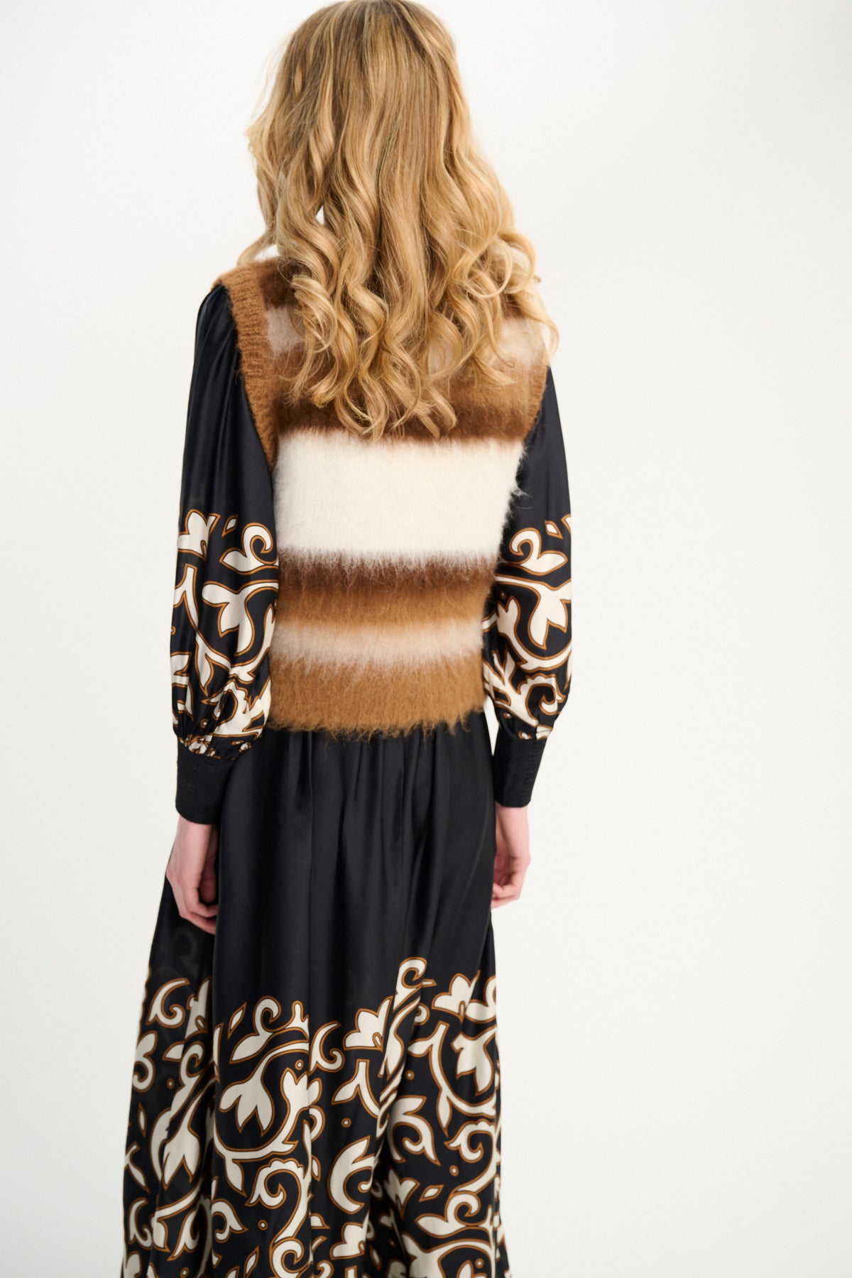 Carolina K fox vest featuring soft fabric and stylish design, displayed on a hanger with a neutral background.