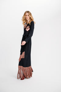 Carolina K Tamzeen dress displayed on a hanger, featuring a stylish, patterned design with flowing fabric and vibrant colors.