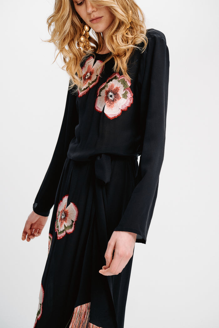 Carolina K Tamzeen dress in vibrant floral print, flowing fabric, and elegant design, shown on a model.