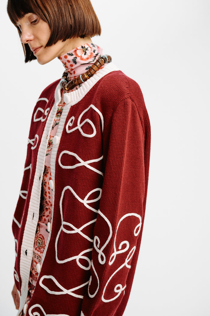 Carolina K Elsa cardigan in soft knit fabric, featuring a cozy fit and stylish design, displayed on a hanger.