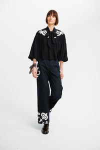 Carolina K Jena Top in soft fabric with a relaxed fit, featuring a stylish neckline and long sleeves.