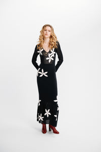 Carolina K Betania dress in vibrant fabric, featuring a flowing silhouette and stylish design, shown on a model.