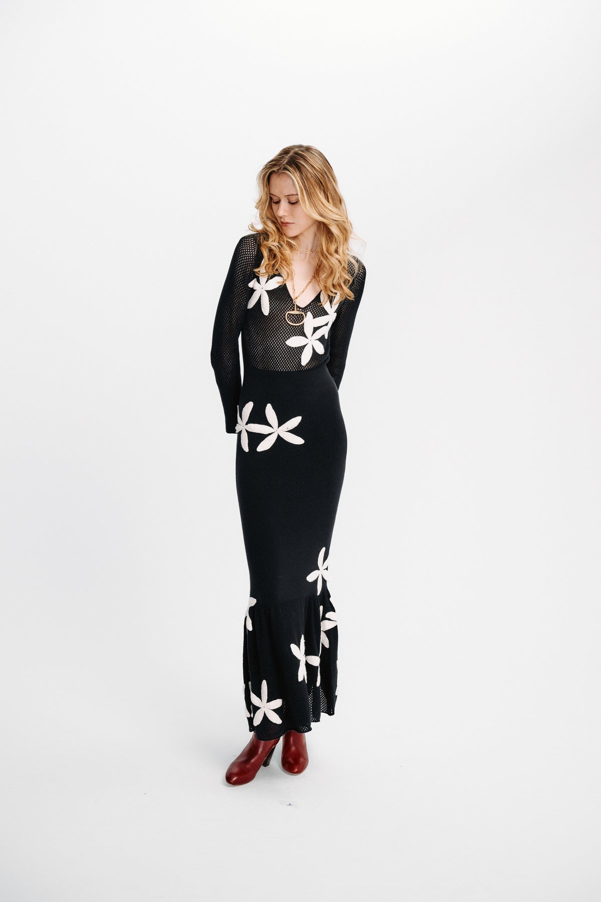 Carolina K Betania dress in vibrant floral print, flowing fabric, and stylish design displayed on a model.