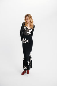 Carolina K Betania dress in vibrant floral print, flowing fabric, and stylish design displayed on a model.