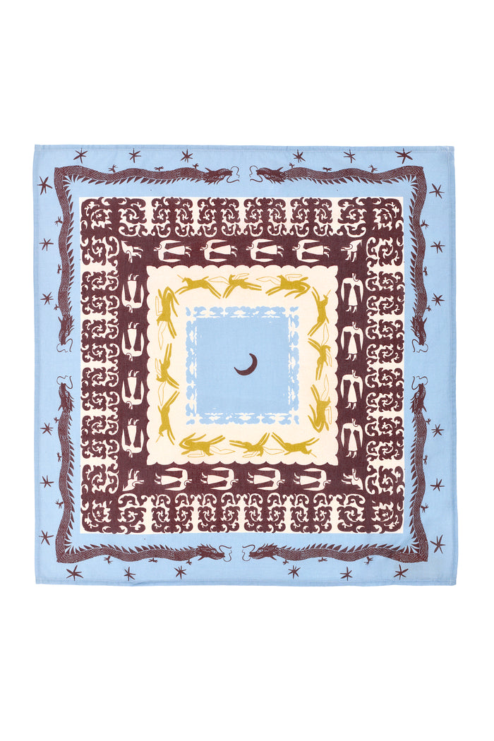 Square bandana featuring a folkloric horse and dragon motif in burgundy, mustard yellow, and cream on a sky-blue background. The design includes intricate symmetrical borders with repeating mythical symbols, stars, and central moon detailing.