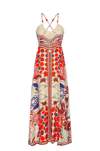 The back showcases crisscross beaded straps and a smocked panel for a comfortable, flexible fit. The flowing skirt drapes beautifully, adding movement and ease to this statement summer dress.