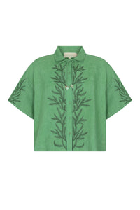 Relaxed-fit linen shirt in a fresh mint hue featuring tonal botanical embroidery along the front and sleeves. Finished with a pointed collar, button-front closure, and shell-inspired tie detail at the neckline.