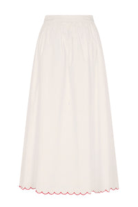 Off-white midi skirt with a clean, flowing silhouette, gathered waistband, and scalloped hem with contrast red embroidery. An effortless piece designed for everyday summer dressing.