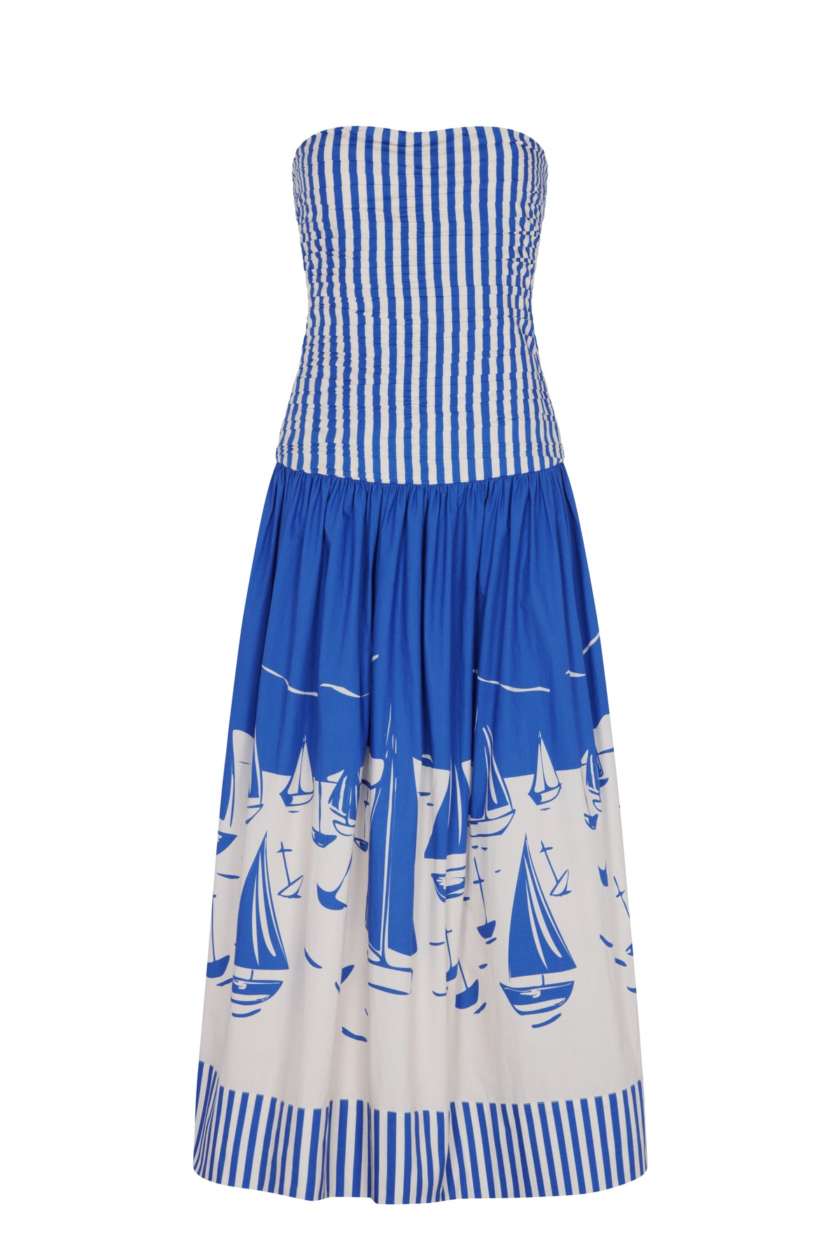 Strapless maxi dress featuring a smocked bodice with vertical blue-and-white stripes and a flowing skirt adorned with a bold sailboat motif. The voluminous silhouette and nautical print create an effortless resort-inspired statement.
