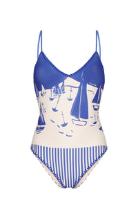 One-piece swimsuit featuring a nautical-inspired sailboat print in vibrant cobalt blue and off-white. Designed with a flattering V-neckline, adjustable shoulder straps, contrast whipstitch trim, and striped detailing at the hips for a fresh coastal look.