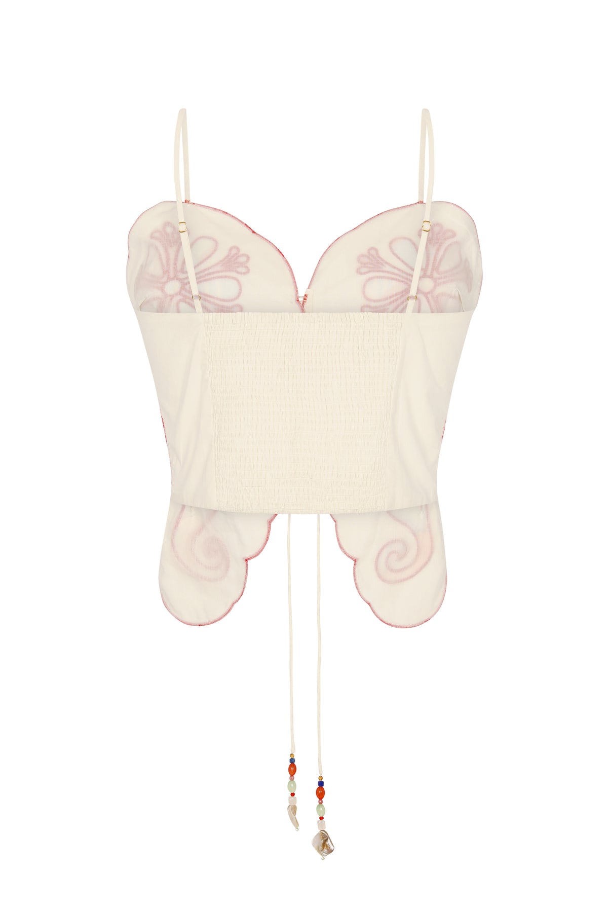 Back view of the off-white embroidered top showcasing adjustable shoulder straps, a smocked elastic back panel for comfort, and scalloped edges outlined with contrast embroidery. Beaded tie cords add a decorative finishing touch.
