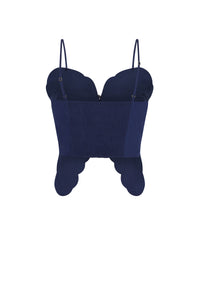 Back view of a navy blue cropped top with thin adjustable straps, smocked back panel, and scalloped hem.