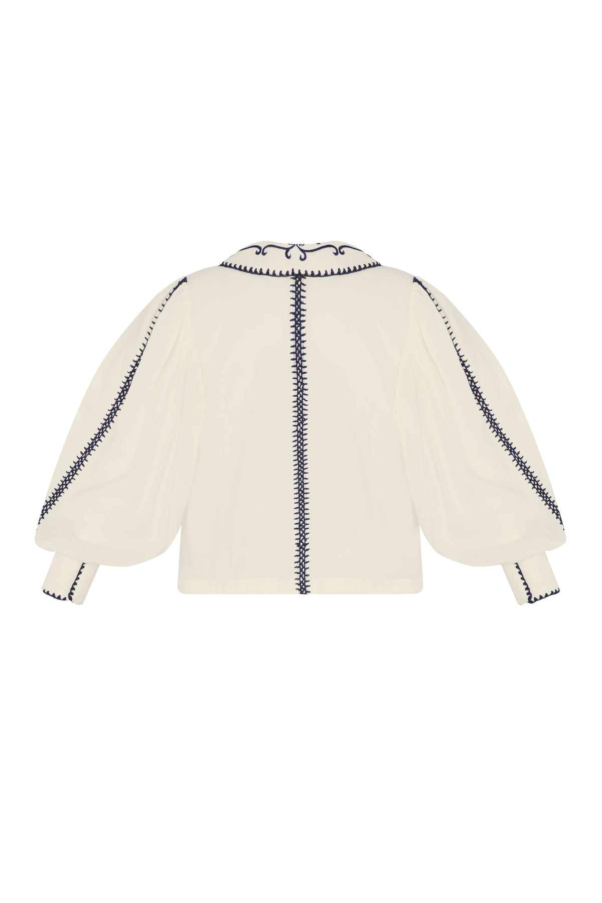 Back view of a cream blouse with voluminous sheer sleeves, navy embroidered trim along the sleeves and center back, and a wide embroidered collar.