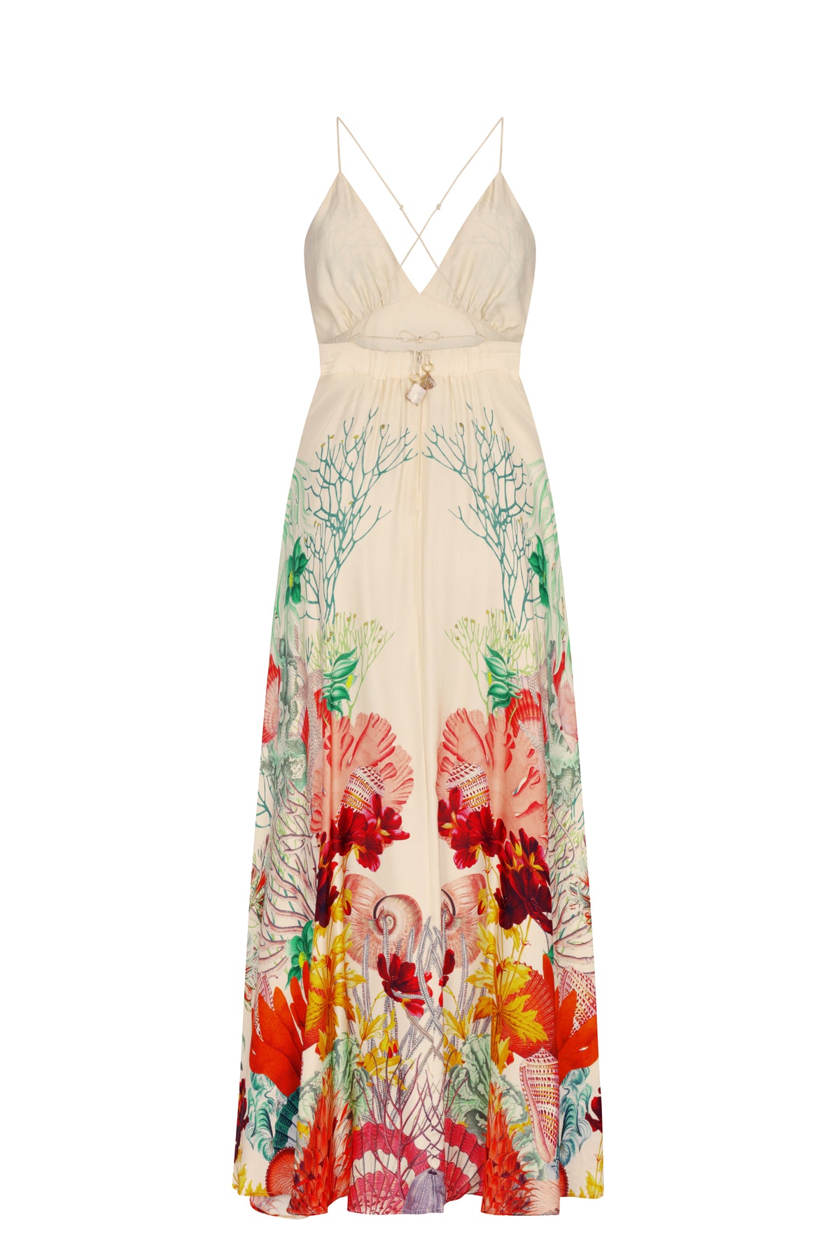Back view of a cream maxi dress with crossed adjustable spaghetti straps and a deep V-back. The full-length skirt features an intricate sea-life print with coral, shells, and colorful botanical elements arranged along the hem and sides, creating a striking tropical coastal design.