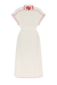 Off-white midi shirt dress with a softly gathered waist, scalloped red-trim detailing along the yoke, sleeves, and hem, and decorative embroidered motifs across the upper back. The relaxed silhouette and short flutter sleeves create an airy, feminine feel.