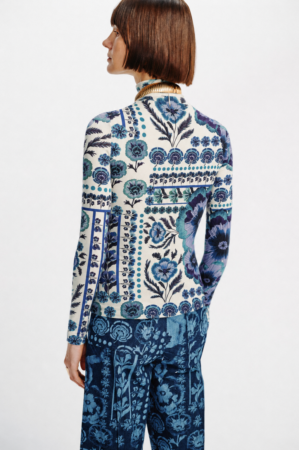 Back view of Carolina K Viento Turtleneck sweater in a soft, fitted knit fabric, showcasing its sleek design and high neckline.